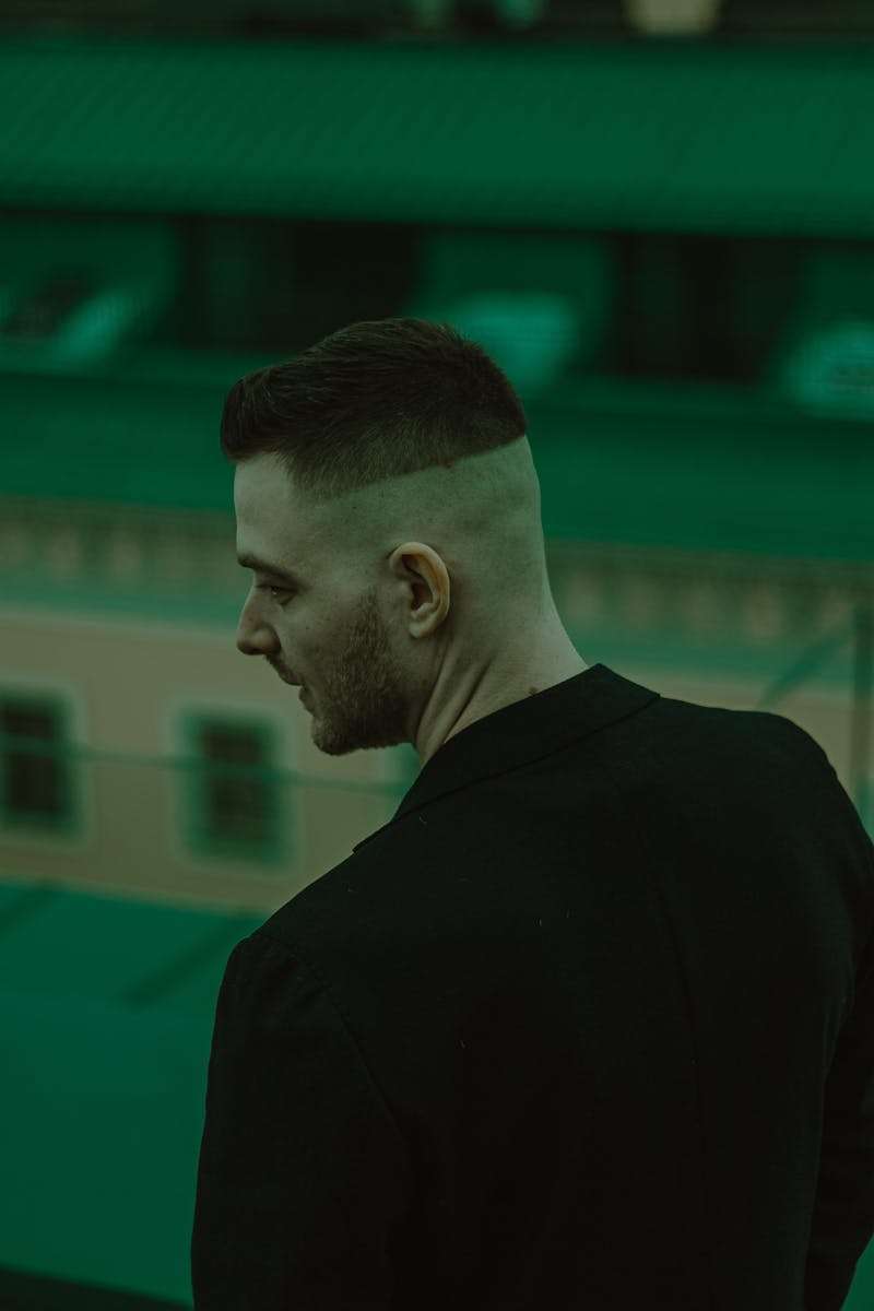 Young Man with Half Shaved Head Standing Backwards