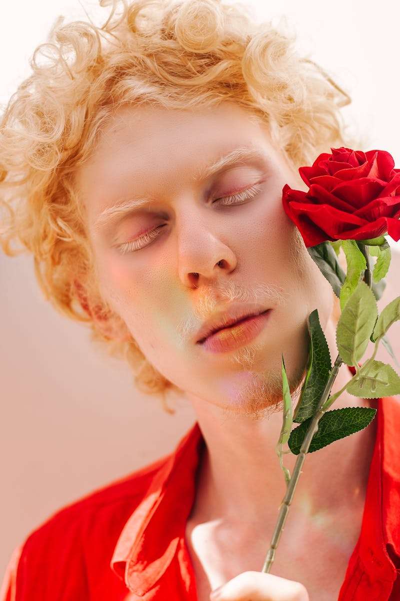 Man Wearing Red Collared Shirt Holding Red Rose Flower