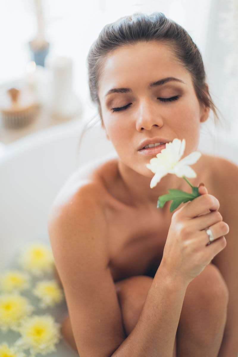 Topless Woman Holding White Flower