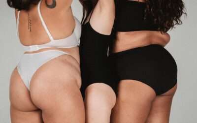 Crop anonymous ethnic overweight and fit women in underwear showing body shapes in studio