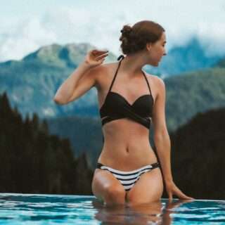 a woman in a bikini standing in a pool