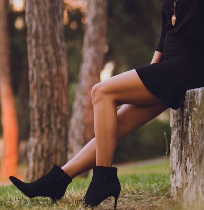 shallow focus photo of person in black booties