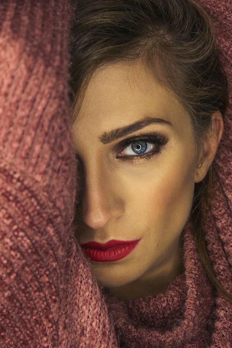 selective focus photography of woman wearing pink sweater